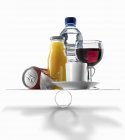 Closeup view of different drinks on scales — Stock Photo