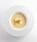 Top view of frothy white wine soup with croutons and rosemary — Stock Photo