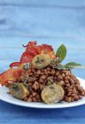 Lentils with limpets and bacon — Stock Photo