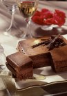 Closeup view of cut chocolate and hazelnut Caraque cake — Stock Photo