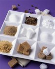 Assorted sugars in white dish — Stock Photo