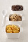 Closeup view of assorted cereals in three bowls — Stock Photo