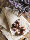 Roasted chestnuts in paper cone — Stock Photo