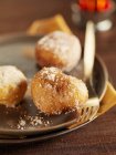 Closeup view of Saint-Nicolas fritters with fork on metal plates — Stock Photo