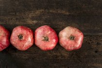 Row of fresh pomegranates — Stock Photo