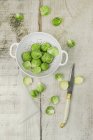 Brussels sprouts on plate over wooden — Stock Photo