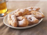 Closeup view of Bugnes with icing sugar — Stock Photo