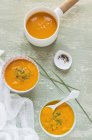 Carrot soup with chives in bowls — Stock Photo