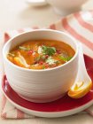Carrot soup with herbs in bowl — Stock Photo