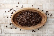 Coffee beans in wooden bowl — Stock Photo