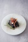 Black risotto with squid — Stock Photo