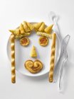 Top view of appetizers in shape of face on white plate — Stock Photo