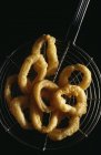 Closeup view of calamari fritters on wire cooling rack — Stock Photo