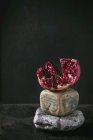 Broken pomegranate on decorative stones — Stock Photo