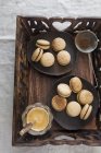 Macarons on wooden tray — Stock Photo