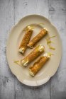 Top view of Brandy snap Tuilles with lemon cream on a plate — Stock Photo