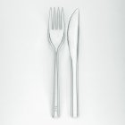 Closeup top view of knife and fork on white surface — Stock Photo