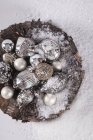 Top view of antique silver baubles heap sprinkled with white powder — Stock Photo