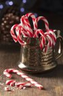 Christmas candy canes in mug — Stock Photo