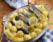 Roasted sardines in oil and potatoes — Stock Photo