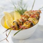 Mussel brochettes on plate — Stock Photo