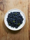 Fresh Blueberries on plate — Stock Photo