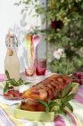 Summer fruit jellied terrine in green dish over cloth on table — Stock Photo