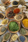 Assorted spices in wooden pots  over wooden surface — Stock Photo