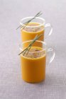 Glass cups of carrot soup — Stock Photo