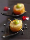 Scallop and carrot Makis over black surface — Stock Photo