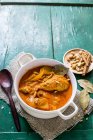 Thai Massaman chicken curry in white dish over textile towel on green wooden surface — Stock Photo