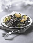 Squid-ink tagliatelles pasta with squid — Stock Photo