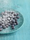 Blueberries with icing sugar — Stock Photo