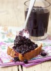 Blueberry jam on slice of bread — Stock Photo