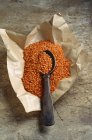 Orange lentils in paper — Stock Photo