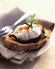 Poached egg with truffles on aubergines — Stock Photo