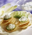 Blinis with cucumber and cream — Stock Photo