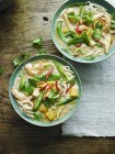 Top view of prawn Laksa with herbs in bowls — Stock Photo