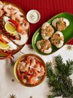 Top view of different seafood dishes with sauce and fir branches — Stock Photo