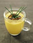 Cream of garlic and saffron in glass jar over table — Stock Photo