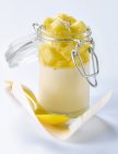 Closeup view of Panacotta dessert in glass jar with spoon on paper — Stock Photo
