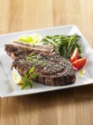 Grilled beef chop on platter — Stock Photo