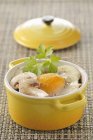 Coddled egg with mushrooms in yellow pan — Stock Photo