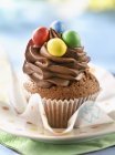 Chocolate cupcake with candies — Stock Photo