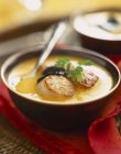 Closeup view of pan-fried scallop cream soup with truffles and herb — Stock Photo