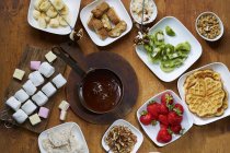 Chocolate fondue with fruit — Stock Photo