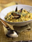Closeup view of Risotto with mussels and herb in bowl — Stock Photo