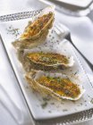 Grilled oysters with chopped parsley — Stock Photo