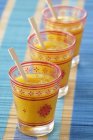 Mango soup in jars with spoons over cloth — Stock Photo