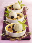 Ice cream scoops on blackberry pies — Stock Photo